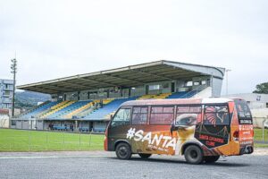 Micro-ônibus do Santa Catarina Clube com a arquibancada ao fundo